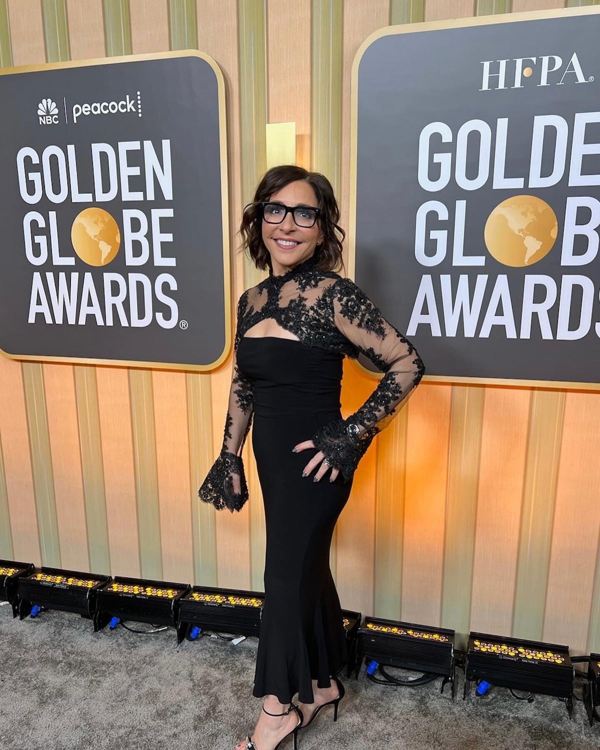 Maryann of Adrienne's on the red carpet in a black lace gown