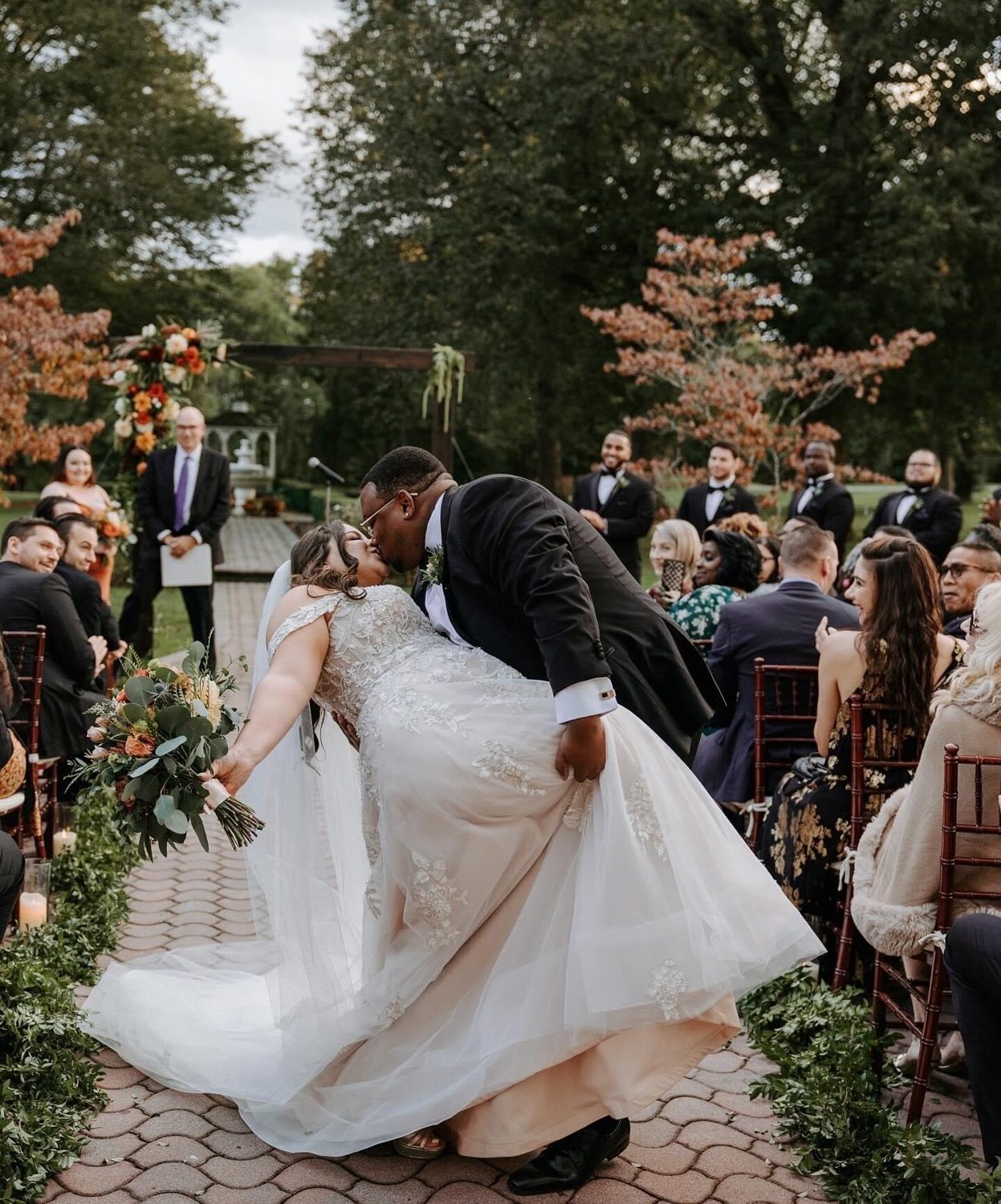 Adrienne's bride in a ball gown at a garden ceremony
